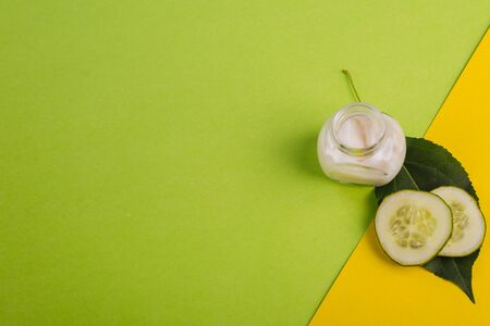 White cucumber cream on a yellow-green background.の写真素材