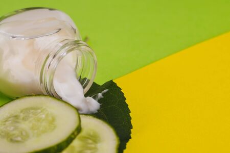 White cucumber cream on a yellow-green background.の写真素材
