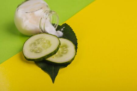 White cucumber cream on a yellow-green background.の写真素材
