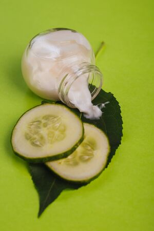 White cucumber cream on a yellow-green background.の写真素材