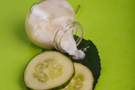 White cucumber cream on a yellow-green background.の写真素材