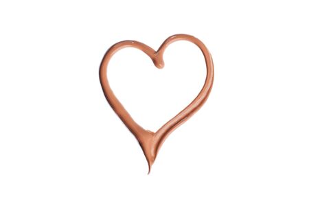 Heart shaped foundation on a white background. Perfect tone. Cosmetic product.の写真素材