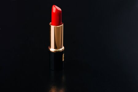 Red lipstick on a black background. Used cosmetics. Ladiesの写真素材
