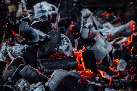 Smoldering coals on the grill with sparks.の写真素材