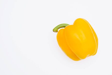 Sweet pepper on a white background. Yellow pepper lies on a light table.の写真素材