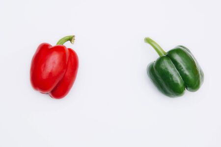Sweet pepper multicolored on a white background. Red and green peppers lie on a light table.の写真素材