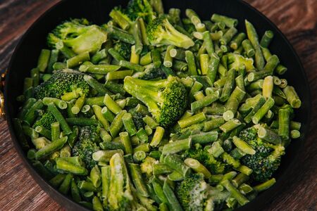 Frozen green cabbage and green beans, semi-finished product in a pan.の写真素材