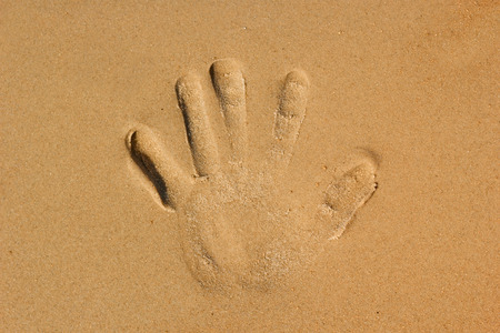 hands palm imprint on the beachの写真素材