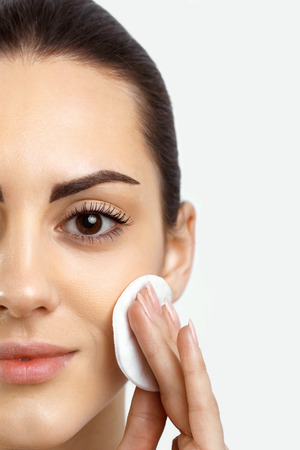 Woman Removing Face Makeup With Cotton Pad.の写真素材