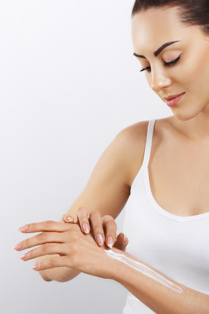Beautiful Woman put Hand Cream, Lotion On Her Hands.の写真素材