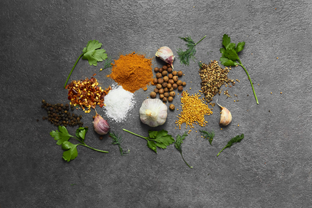 Selection of spices, herbsl on black stone table. Ingredients for cooking. Food background. Top view with copy space.の写真素材