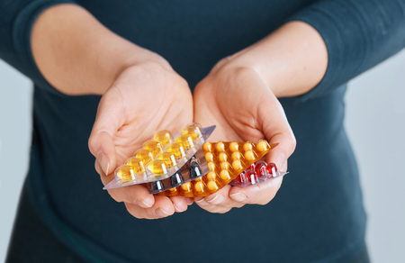 Vitamins And Supplements. Closeup Of Woman Hands Holding Variety Of Colorful Vitamin Pills. Close-up Handful Of Medication, Medicine Tablets, Capsules. Healthy Diet Nutrition Concept.の写真素材