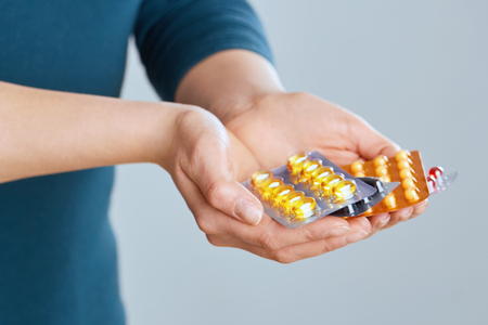 Vitamins And Supplements. Closeup Of Female Hand Holding Variety Of Colorful Pills On Palm. Close-up Of Woman Fingers Taking Medication Tablets, Capsules From Hand. Medicine Concept. High Resolution - Imageの写真素材