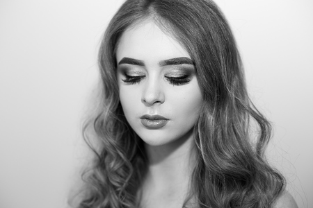 Beautiful model girl with Fashion Luxury Makeup, long eyelashes, perfect skin facial make-up. Beauty Brunette model woman holiday make up close up. Eyelash extensions, false eyelashes. Beauty Woman.の写真素材