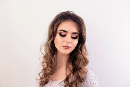 Beautiful model girl with curly hair. Beautiful Young Female with Clean Fresh Skin close up.Skin care face. Cosmetology. Beauty Woman face Portrait.の写真素材