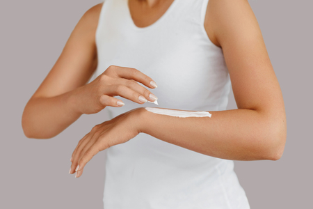 Hand Skin Care. Close Up Of Female Hands Holding Cream Tube, Beautiful Woman Hands With Natural Manicure Nails Applying Cosmetic Hand Cream On Soft Silky Healthy Skin. Beauty And Body Care Conceptの写真素材