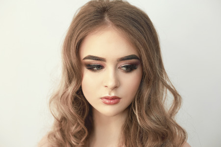Beautiful model girl with Fashion Luxury Makeup, long eyelashes, perfect skin facial make-up. Beauty Brunette model woman holiday make up close up. Eyelash extensions, false eyelashes. Beauty Woman.の写真素材
