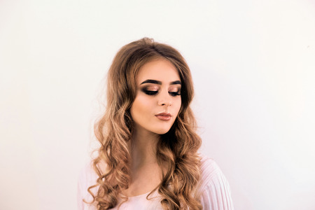 Beautiful model girl with curly hair. Beautiful Young Female with Clean Fresh Skin close up.Skin care face. Cosmetology. Beauty Woman face Portrait.の写真素材