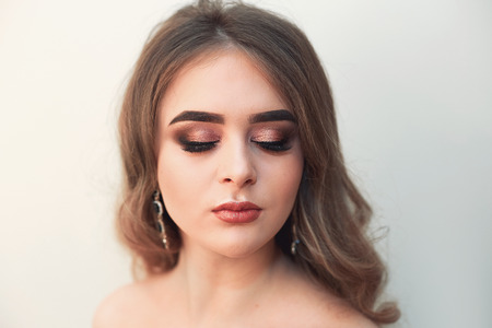 Beautiful model girl with Fashion Luxury Makeup, long eyelashes, perfect skin facial make-up. Beauty Brunette model woman holiday make up close up. Eyelash extensions, false eyelashes. Beauty Woman.の写真素材