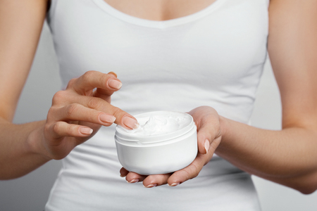 Hand Skin Care. Close Up Of Female Hands Holding Cream Tube, Woman Hands With Natural Manicure Nails Applying Cosmetic Hand Cream On Soft Silky Healthy Skin. Beauty And Body Care Conceptの写真素材