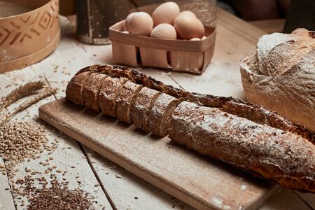 Freshly baked bread .Top view of sliced wholegrain bread on dark rustic wooden  background closeup....