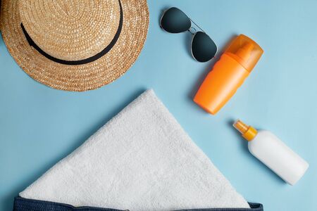 Beach flat lay accessories. Sun hat,  towel,cream, sunscreen bottle, sun cream, lotion bottle,...