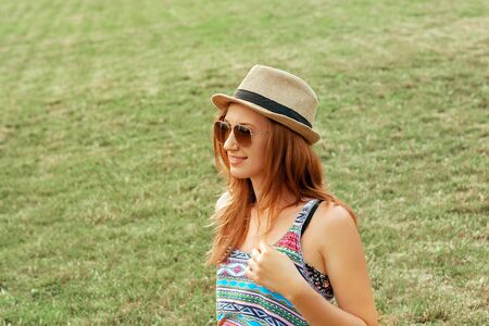 Beautiful Attractive young woman smiling and enjoying  in park with hat.