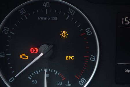Tachometer dial with needle showing zero rpm with diagnostic icons isolated on black background