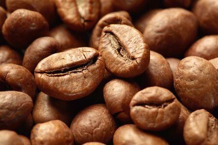 Roasted coffee beans close up. Espresso dark, aroma, black caffeine drink