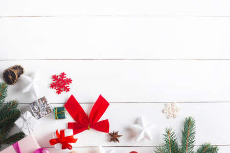 Beautiful Christmas composition on wooden white background with Christmas gift boxes, snowy fir...