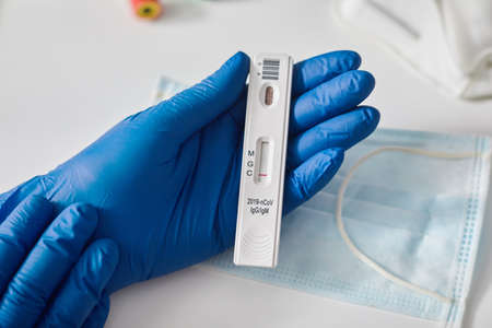 Doctor holding a test kit for viral disease COVID-19 2019-nCoV. Lab card kit test for viral...
