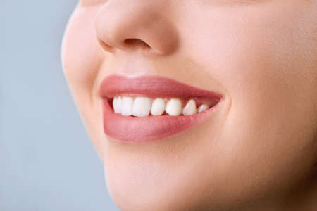 Closeup of smile with white healthy teeth.Teeth whitening. Dental care. Lips careの写真素材