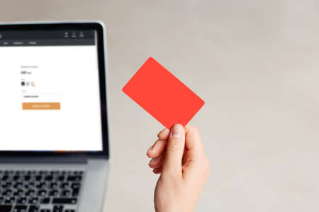 Young woman holding credit card and typing on laptop, shopping online home concept. Internet banking, spending moneyの写真素材
