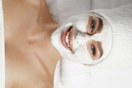Beautiful woman with facial mask, spa treatment.Face peeling mask. skin care.の写真素材