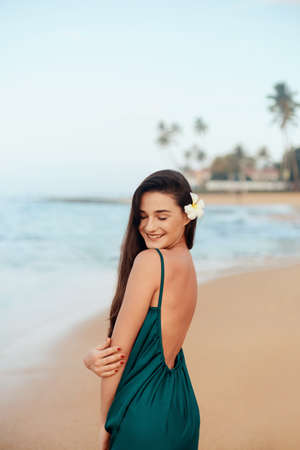 Happy woman on the beach. Ð¡lose-up portrait of the beautiful girl. Young pretty girl. Young smiling woman outdoors portrait.の写真素材