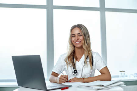 Female doctor working with her laptop in medical officeの写真素材
