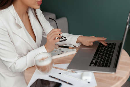 Woman hands typing on laptop keyboard at the office, Woman worker and business concept.