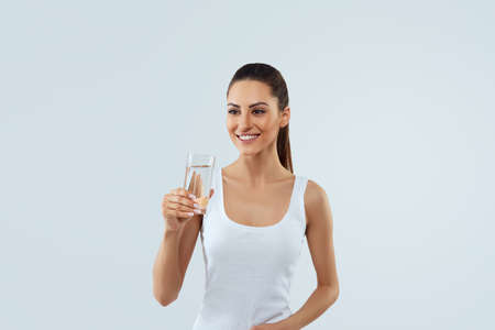 Beautiful woman holding water glass. drink water. girl with glass of water. Diet concept