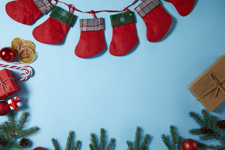 Beautiful Christmas composition on blue background. Christmas present boxes, socks, fir spruce...