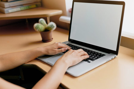 woman using laptop, searching web, browsing information, having workplace at home. Vintage concept