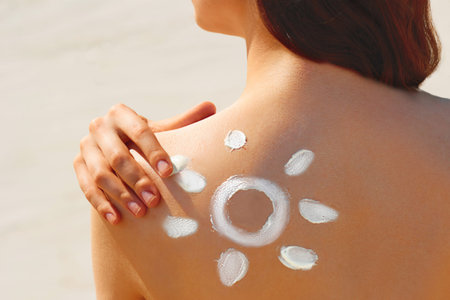 Portrait of woman in bikini with the drawn sun on a shoulder at beach