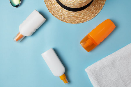 Sun cream, sun hat cream, sunscreen bottle, sun cream, lotion bottle, seashells. Beach flat lay...