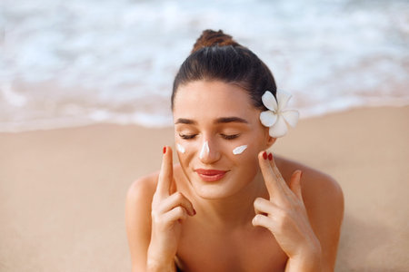 Beautiful Woman Face Portrait Beauty Skin Care Concept. Suncream. Suntan Lotion Beautiful Woman...