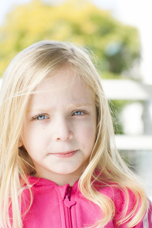 Portrait of a girl in black dress. Charming child with air baloons posing on white background indoors. Studio shotの写真素材