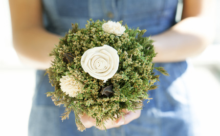 Beautiful wedding bouquet in hands of the bride close upの写真素材