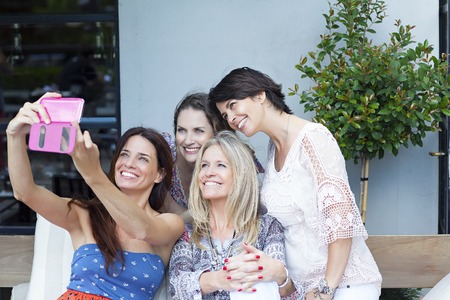 group of friends taking photos with a smartphone