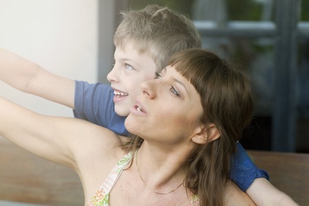 young mother with her son dancing outdoors