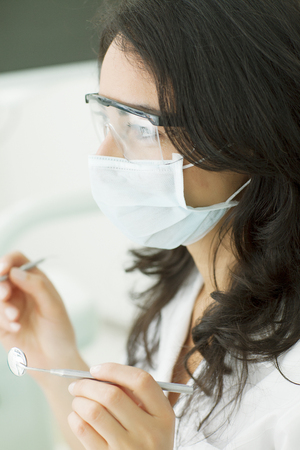 Happy female dentist working at Dental officeの写真素材