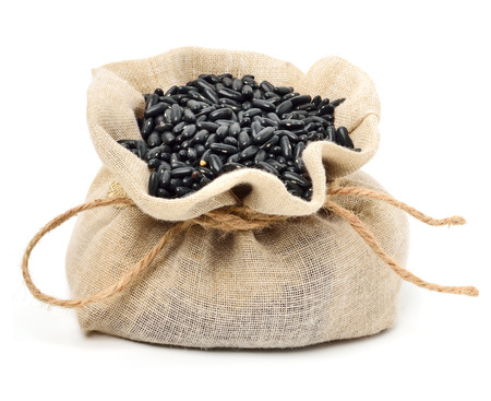 Black beans in the sack isolated on whiteの写真素材