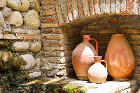 Old clay jugs in the brick and stone placeの写真素材
